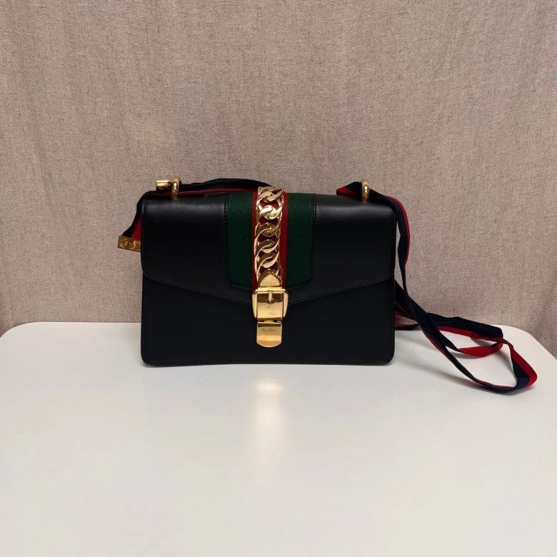 Women Gucci tote bags in GG Supreme canvas for a branded feelGucci Sylvie Black Leather Top Handle Bag Medium Size