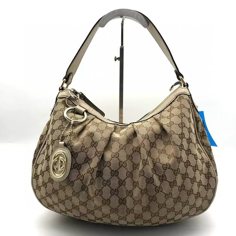 Women Gucci bags with interlocking G hardware for a classic lookGucci Beige Monogram Canvas Shoulder Bag Medium